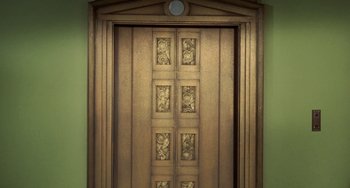 Movie still from “Watermelon Man” (1970), directed by Melvin Van Peebles – An ornate wooden door in a room with green walls; Wide shot, Overhead angle