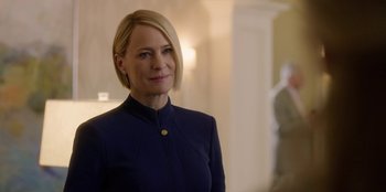 Movie still from “House of Cards” (2013), created by Beau Willimon – A person wearing a suit; Close Up shot, Over the shoulder angle