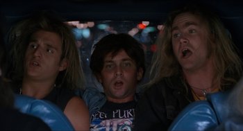 Movie still from “Wayne's World” (1992), directed by Penelope Spheeris – A group of young people riding in a car; Medium shot, Low angle