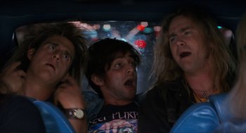 Movie still from “Wayne's World” (1992), directed by Penelope Spheeris – A group of people riding a roller coaster at night; Medium shot, Low angle