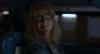 Movie still from “Wayne's World” (1992), directed by Penelope Spheeris – A woman with long blonde hair wearing glasses; Close Up shot, Low angle