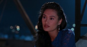 Movie still from “Wayne's World” (1992), directed by Penelope Spheeris – A beautiful young woman with long black hair; Close Up shot, Over the shoulder angle