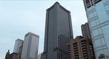 Movie still from “Wayne's World” (1992), directed by Penelope Spheeris – A tall building in the middle of a large city; Extreme Wide shot, High angle