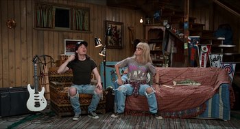 Movie still from “Wayne's World” (1992), directed by Penelope Spheeris – A couple of people that are sitting on a couch; Wide shot, High angle
