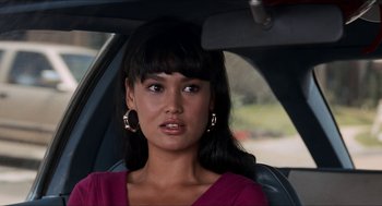 Movie still from “Wayne's World” (1992), directed by Penelope Spheeris – A woman sitting in the back seat of a car; Close Up shot, Over the shoulder angle