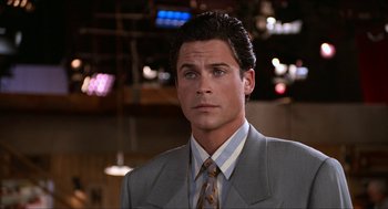 Movie still from “Wayne's World” (1992), directed by Penelope Spheeris – A man in a suit and tie; Close Up shot, Over the shoulder angle