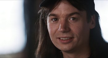 Movie still from “Wayne's World” (1992), directed by Penelope Spheeris – A person with long hair; Close Up shot, Over the shoulder angle