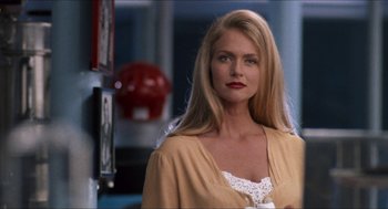 Movie still from “Wayne's World” (1992), directed by Penelope Spheeris – A woman with long blonde hair wearing a white top; Close Up shot, Over the shoulder angle