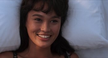 Movie still from “Wayne's World” (1992), directed by Penelope Spheeris – A person with a smile on their face; Close Up shot, Over the shoulder angle