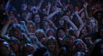 Movie still from “Wayne's World” (1992), directed by Penelope Spheeris – A large crowd of people at an event; Wide shot, High angle