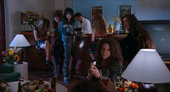 Movie still from “Wayne's World” (1992), directed by Penelope Spheeris – A group of people sitting around a bar; Wide shot, Over the shoulder angle