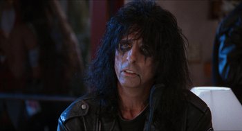 Movie still from “Wayne's World” (1992), directed by Penelope Spheeris – A person wearing a leather jacket; Close Up shot, Over the shoulder angle