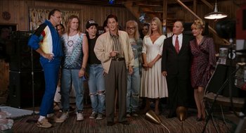 Movie still from “Wayne's World” (1992), directed by Penelope Spheeris – A group of people standing next to each other in a room; Wide shot, High angle