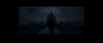 Movie still from “We Summon the Darkness” (2019), directed by Marc Meyers – A man standing in front of a building in the dark; Extreme Wide shot, Low angle