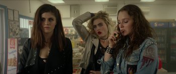 Movie still from “We Summon the Darkness” (2019), directed by Marc Meyers – A group of young women standing next to each other in a room; Medium shot, Over the shoulder angle