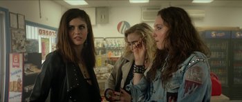 Movie still from “We Summon the Darkness” (2019), directed by Marc Meyers – A group of women standing around each other in a store; Medium shot, Over the shoulder angle