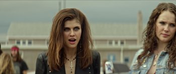 Movie still from “We Summon the Darkness” (2019), directed by Marc Meyers – A beautiful woman with long brown hair wearing a black jacket; Close Up shot, Over the shoulder angle