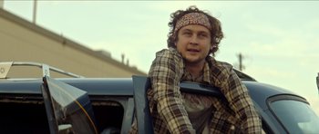 Movie still from “We Summon the Darkness” (2019), directed by Marc Meyers – A man sitting in the back of a truck; Close Up shot, Low angle