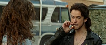 Movie still from “We Summon the Darkness” (2019), directed by Marc Meyers – A man and a woman standing next to each other; Close Up shot, Over the shoulder angle