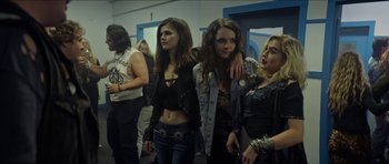 Movie still from “We Summon the Darkness” (2019), directed by Marc Meyers – A group of young women standing next to each other in a room; Medium shot, Over the shoulder angle