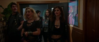 Movie still from “We Summon the Darkness” (2019), directed by Marc Meyers – A group of women standing next to each other in front of a door; Medium shot, Over the shoulder angle