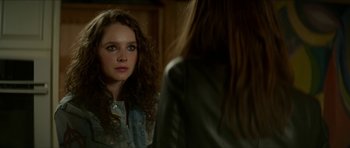 Movie still from “We Summon the Darkness” (2019), directed by Marc Meyers – A woman looking at her reflection in a mirror; Close Up shot, Over the shoulder angle