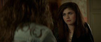 Movie still from “We Summon the Darkness” (2019), directed by Marc Meyers – A woman looking into a mirror with a cross in her ear; Close Up shot, Over the shoulder angle