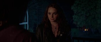 Movie still from “We Summon the Darkness” (2019), directed by Marc Meyers – A woman in a leather jacket is looking at the camera; Close Up shot, Over the shoulder angle