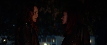 Movie still from “We Summon the Darkness” (2019), directed by Marc Meyers – Two women standing next to each other in the dark; Close Up shot, Over the shoulder angle