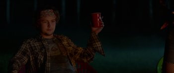 Movie still from “We Summon the Darkness” (2019), directed by Marc Meyers – A person holding a cup in their hand; Medium shot, Over the shoulder angle