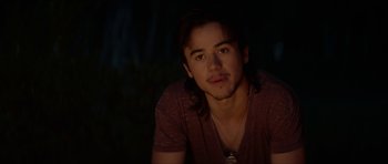 Movie still from “We Summon the Darkness” (2019), directed by Marc Meyers – A man with long hair is sitting in the dark; Close Up shot, Over the shoulder angle