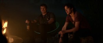 Movie still from “We Summon the Darkness” (2019), directed by Marc Meyers – Two men sitting on a chair in a dark room; Medium shot, Over the shoulder angle