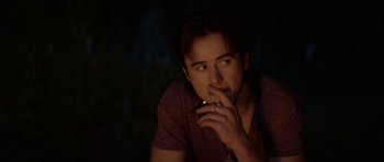 Movie still from “We Summon the Darkness” (2019), directed by Marc Meyers – A man smoking a cigarette in the dark; Close Up shot, Over the shoulder angle
