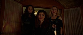 Movie still from “We Summon the Darkness” (2019), directed by Marc Meyers – A group of women standing next to each other in a room; Medium shot, High angle
