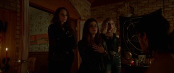 Movie still from “We Summon the Darkness” (2019), directed by Marc Meyers – A group of women standing next to each other in front of a brick wall; Medium shot, Low angle