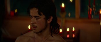 Movie still from “We Summon the Darkness” (2019), directed by Marc Meyers – A man with long black hair is looking at the camera; Close Up shot, Over the shoulder angle