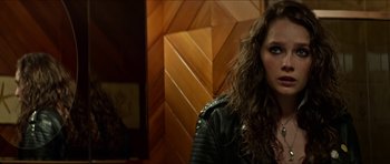 Movie still from “We Summon the Darkness” (2019), directed by Marc Meyers – A person wearing a leather jacket; Close Up shot, Over the shoulder angle