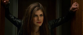 Movie still from “We Summon the Darkness” (2019), directed by Marc Meyers – A beautiful woman with long brown hair wearing a leather jacket; Close Up shot, Over the shoulder angle