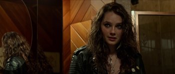 Movie still from “We Summon the Darkness” (2019), directed by Marc Meyers – A person wearing a leather jacket; Close Up shot, Over the shoulder angle