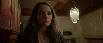 Movie still from “We Summon the Darkness” (2019), directed by Marc Meyers – A woman with long brown hair wearing a leather jacket; Close Up shot, Over the shoulder angle