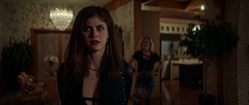 Movie still from “We Summon the Darkness” (2019), directed by Marc Meyers – Two women are standing in a living room; Medium shot, Over the shoulder angle