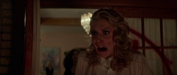 Movie still from “We Summon the Darkness” (2019), directed by Marc Meyers – A person with a surprised look on their face; Close Up shot, Low angle