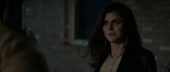 Movie still from “We Summon the Darkness” (2019), directed by Marc Meyers – A beautiful woman with long dark brown hair and a cross necklace; Close Up shot, Over the shoulder angle