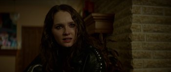 Movie still from “We Summon the Darkness” (2019), directed by Marc Meyers – A woman with long hair wearing a leather jacket; Close Up shot, Over the shoulder angle
