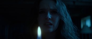 Movie still from “We Summon the Darkness” (2019), directed by Marc Meyers – A person holding a candle; Close Up shot, Over the shoulder angle
