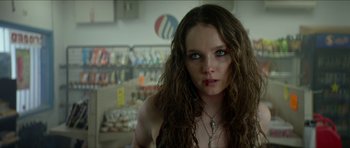 Movie still from “We Summon the Darkness” (2019), directed by Marc Meyers – A person with long hair; Close Up shot, Low angle