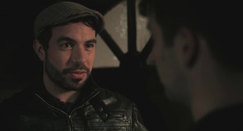 Movie still from “Weekend” (2011), directed by Andrew Haigh – A man wearing a leather jacket and a hat; Close Up shot, Over the shoulder angle