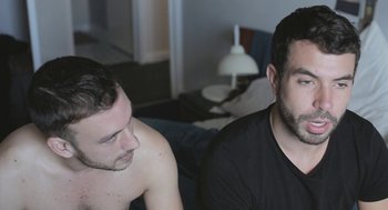 Movie still from “Weekend” (2011), directed by Andrew Haigh – Two men sitting next to each other on a bed; Close Up shot, Over the shoulder angle