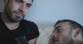 Movie still from “Weekend” (2011), directed by Andrew Haigh – A man is taking a picture of another man in bed; Close Up shot, Over the shoulder angle