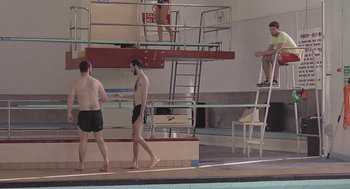 Movie still from “Weekend” (2011), directed by Andrew Haigh – A group of men standing next to a diving board; Wide shot, Low angle